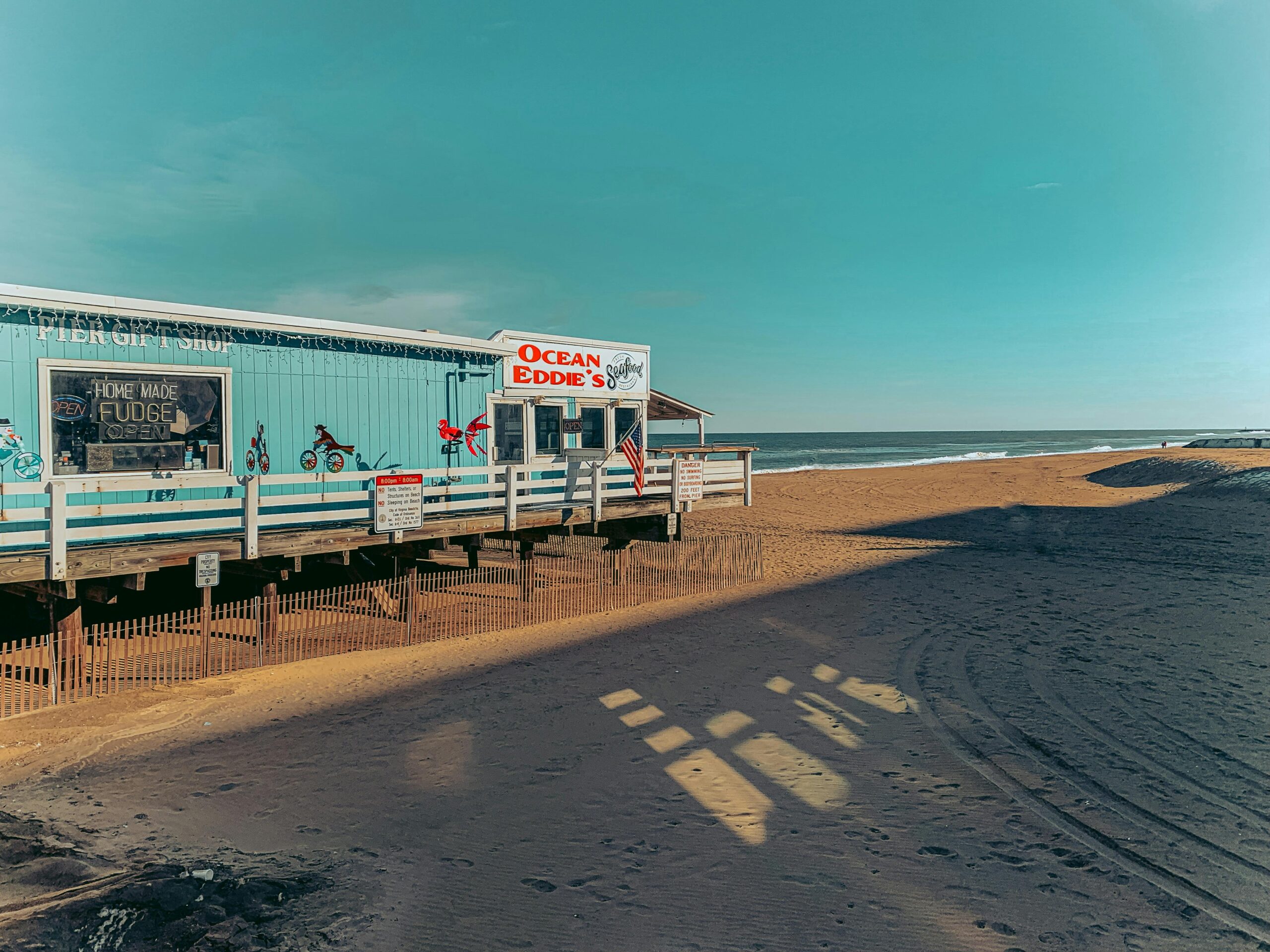 Charming beachside cafe with ocean view on a sunny day, ideal for coastal lifestyle imagery.